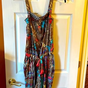 Multi colored jumpsuit worn with or without straps. Gathered waist.